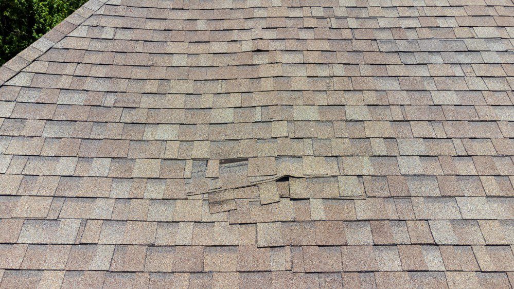 Wind damaged shingle roof that needs to be repaired