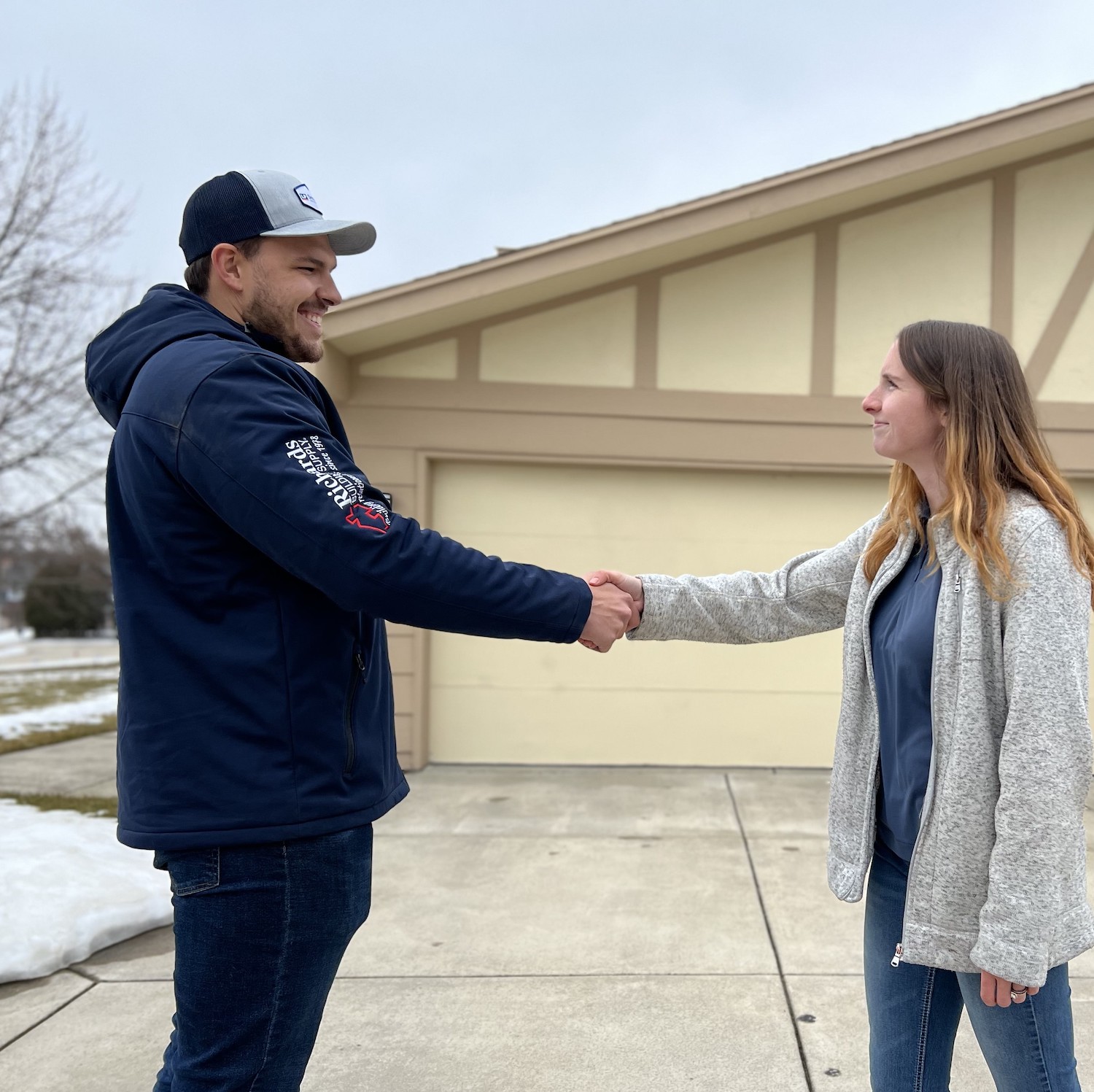 A roofing project consultant guy shaking hands with his client agreeing about the roof repair in Milwaukee