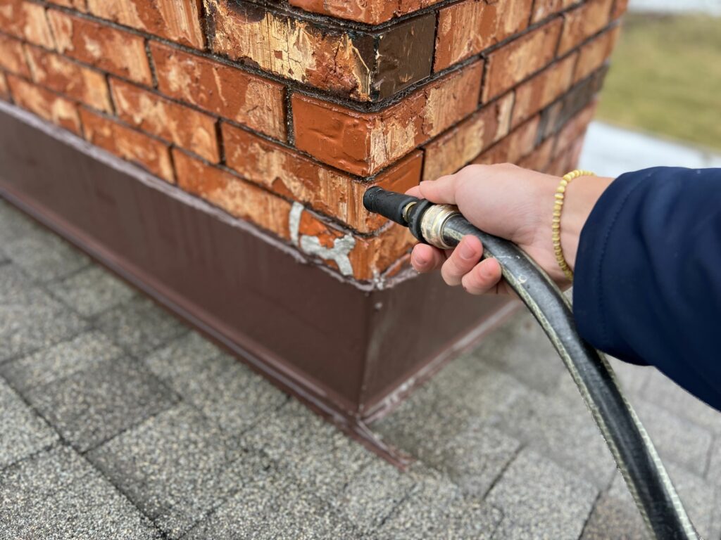 Using water to check for roof chimney leaks