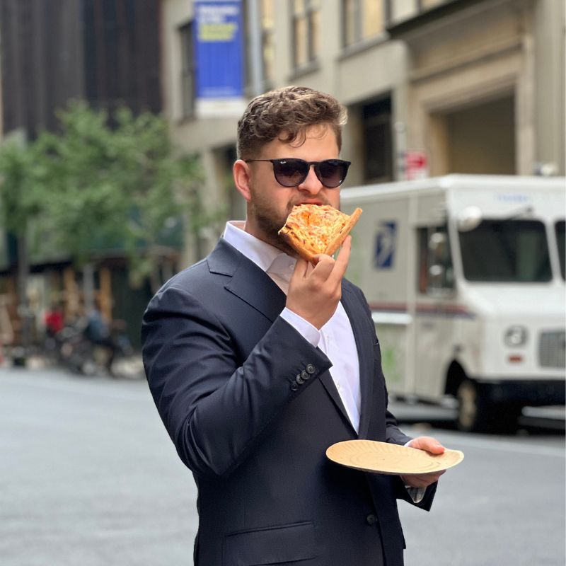 Co-Marketing Director Headshot Phillipp eating pizza