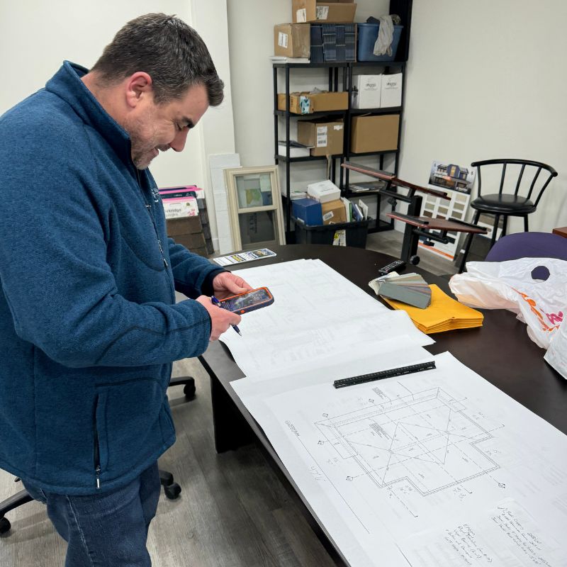 Construction Planner Calculating measurements for a project off of blueprints.