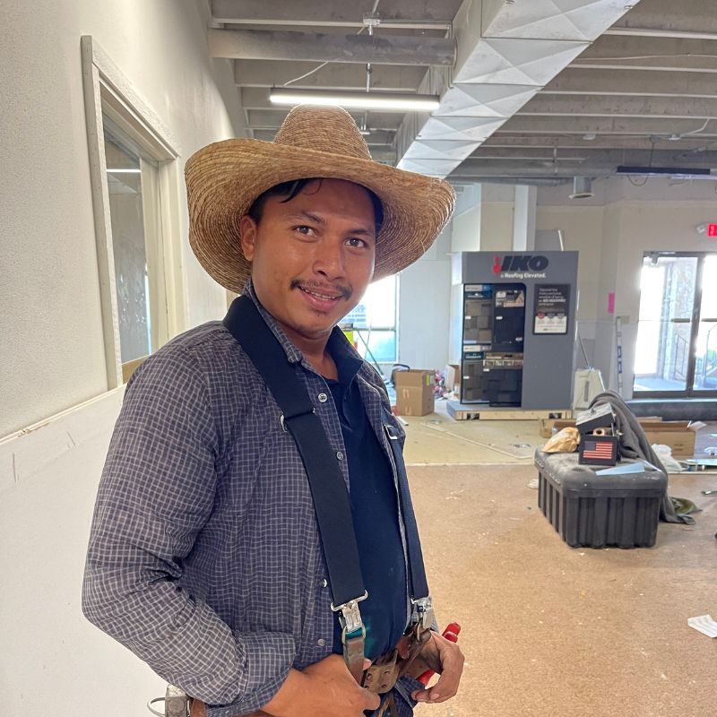Picture of a roofer inside a building with a cowboy hat