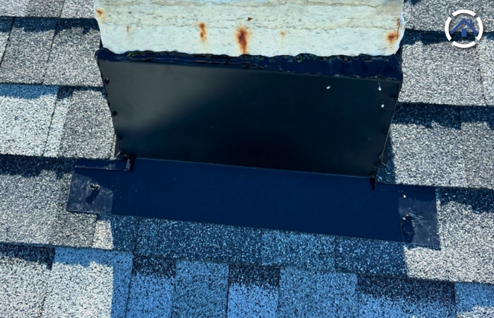 Components of Chimney Flashing — A newly installed black chimney flashing - front side