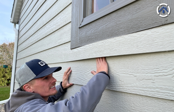 A professional siding installer inspecting a newly installed LP Smart Side — one of the Best Siding Materials
