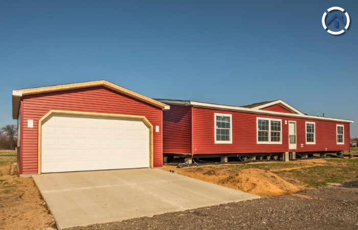 A red manufactured house which was built off-site and then transported to their final location