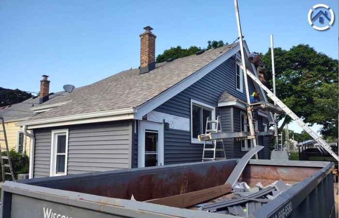 A vinyl siding being installed on a home by a professional installer or siding technician.